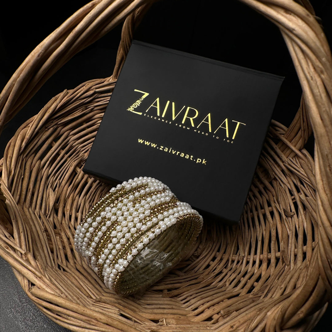 Pearl bangle with golden stones